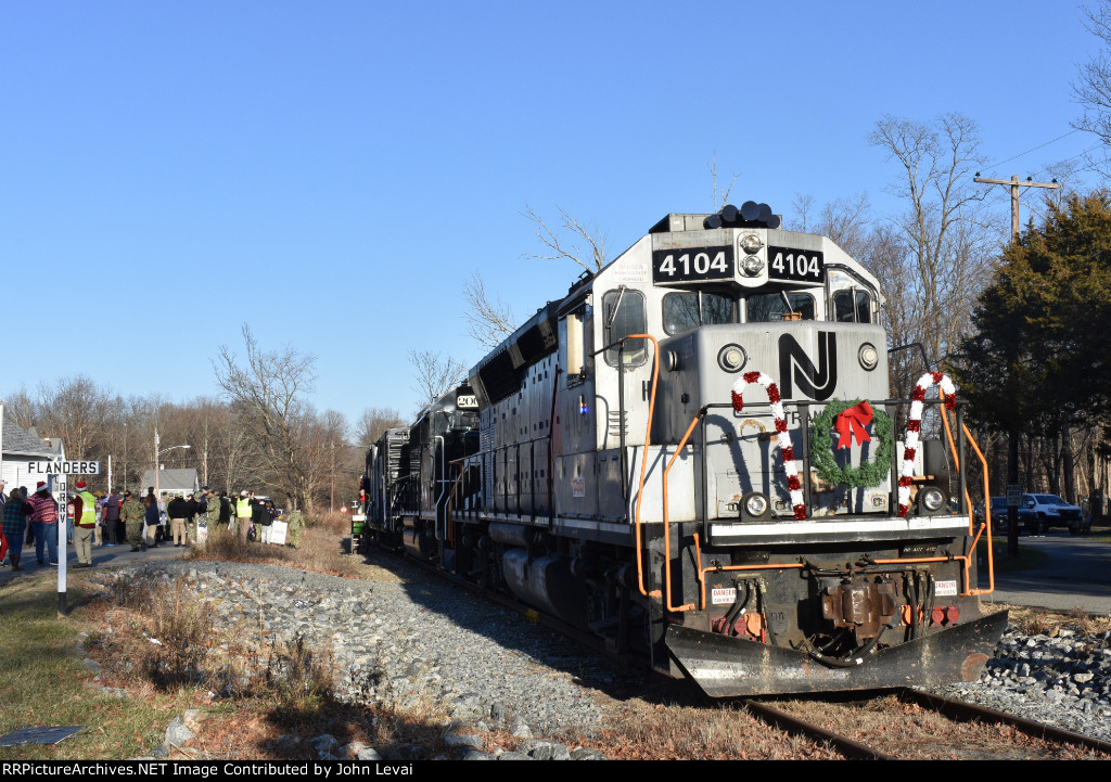 The train rests right next to the Flanders Fire Department, located out of view on the left